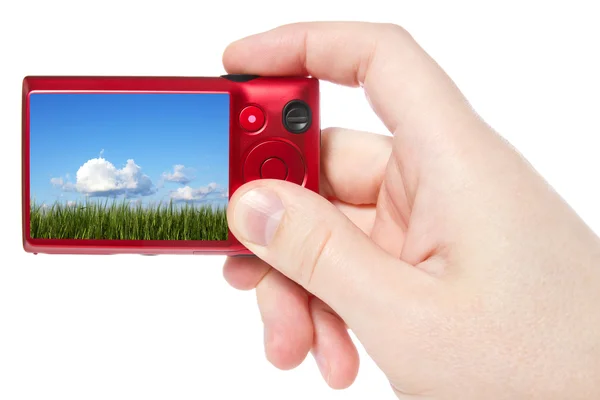 Mão segure a câmara com imagens da natureza — Fotografia de Stock