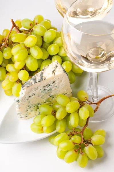 Dvě sklenky bílého vína, modrý sýr a hrozny — Stock fotografie