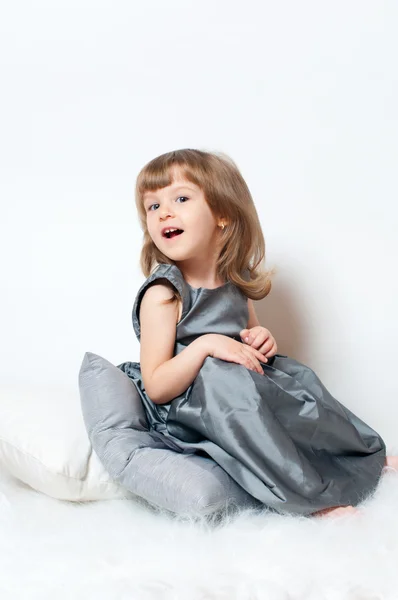Little girl in a dress sitting — Stock fotografie