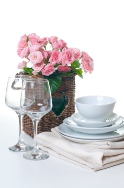 Dishes, towels and a basket of flowers clipart