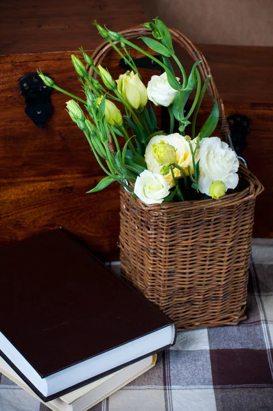 Yellow flowers in a wicker basket — Stock Photo, Image