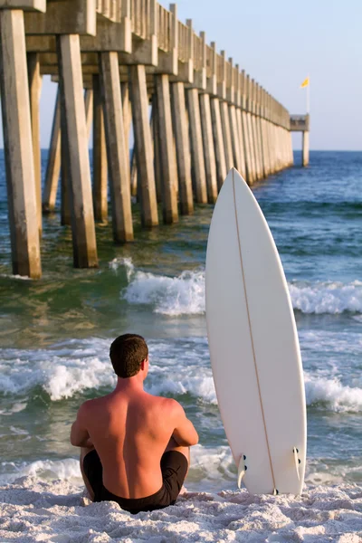 Surfboarder door pier — Stockfoto