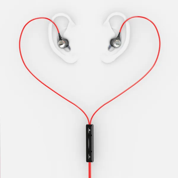 Öron och hörlurar i form av hjärta — Stockfoto