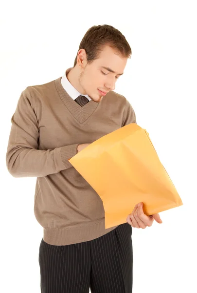 Young man opens a post package — Stock Photo, Image
