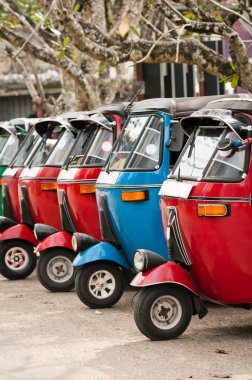 Tuk-tuk is a popular asian transport as a taxi. clipart