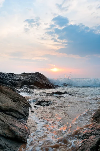 Beautiful stones and waves at sunset — Stock Photo, Image