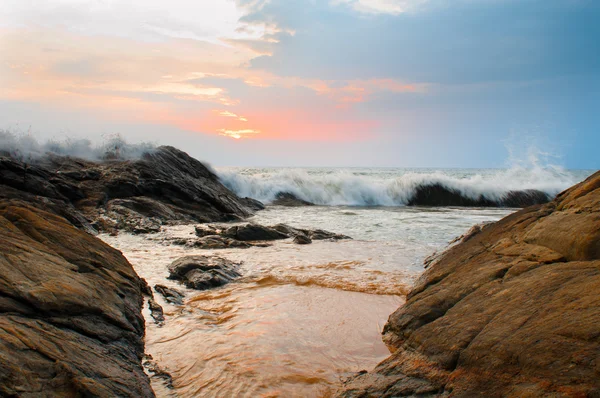 Beautiful stones and waves at sunset — Stock Photo, Image