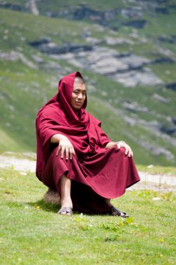 Buddhist monk in mountains clipart