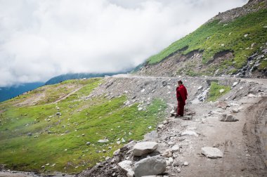 Buddhist monk in mountains clipart