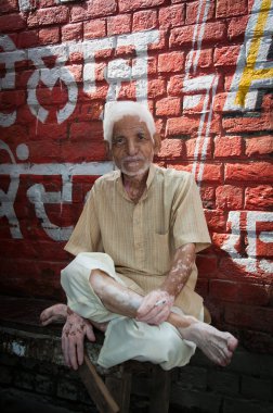 Good-natured senior indian man with cigarette clipart