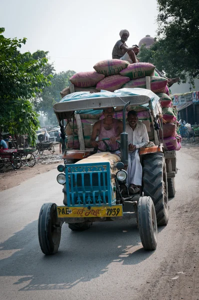 Smiling workers on the overfull by sacks tractor, India — Stock Photo, Image
