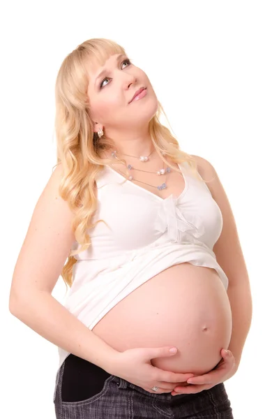 Mujer embarazada acariciando su vientre y soñando —  Fotos de Stock