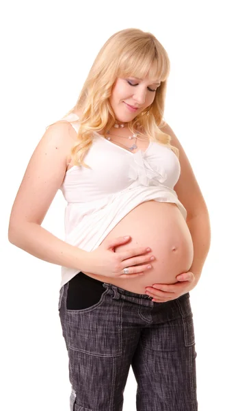 Hamile bir kadın karnını okşuyor. — Stok fotoğraf