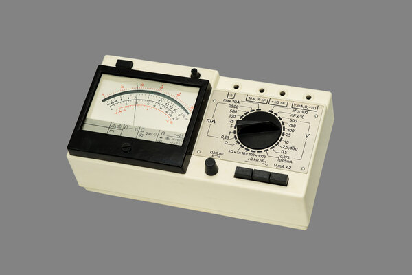 Analog Multimeter, close-up, isolated on a gray background.