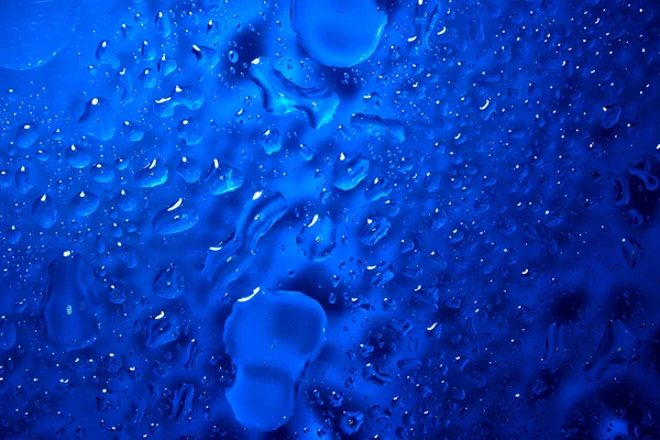 Tmavě modré tekuté kapičky — Stock fotografie