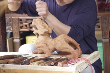 Artist manually making an statue clipart