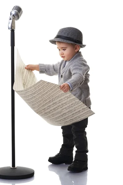 Baby boy reading music notes — Stock Photo, Image