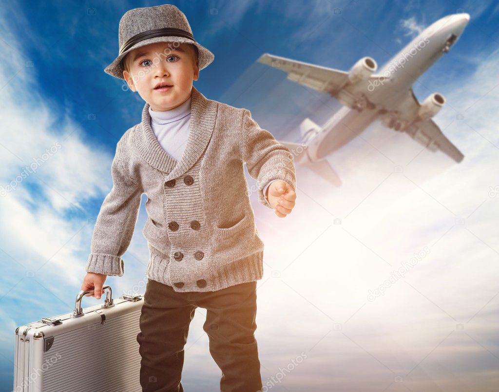 Baby boy with a briefcase against airplane — Stock Photo © nejron 10204350
