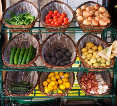 Vegetables in baskets on market place. clipart