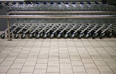 Empty shopping trolleys in a market clipart