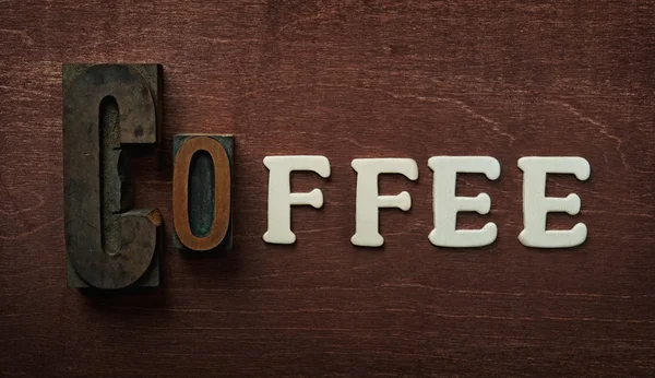 stock image The word coffee written on wooden background