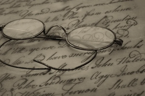 Old glasses on the vintage document — Stock Photo, Image