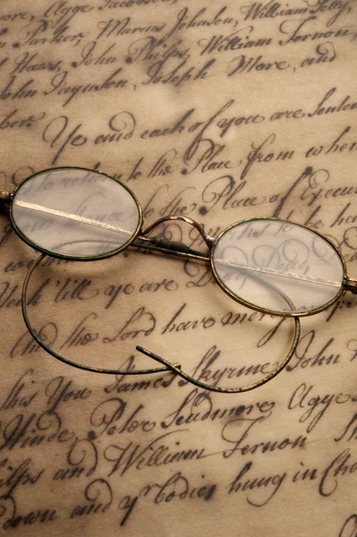 Old glasses on the vintage document — Stock Photo, Image