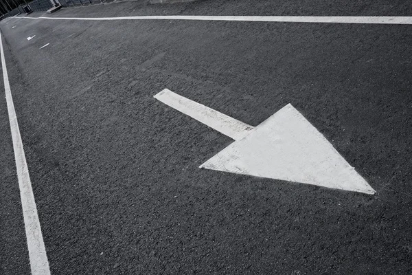 Drawn arrow on a lane. — Stock Photo, Image