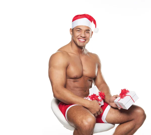 The person in the Christmas suit, sitting on a chair and holding — Stock Photo, Image