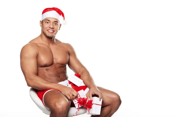 The person in the Christmas suit, sitting on a chair and holding — Stock Photo, Image
