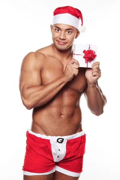 Image of sexy male wearing xmas costume and holding a gift — Stock Photo, Image