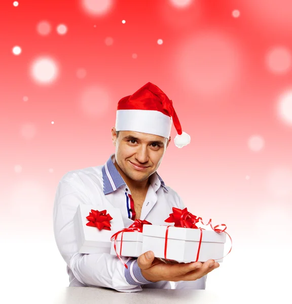 Afbeelding van aantrekkelijke man met Kerst presenteert — Stockfoto