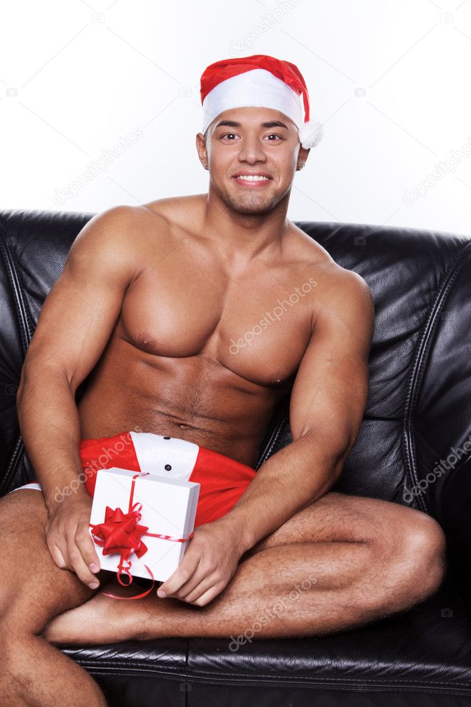 Muscular man sitting on couch