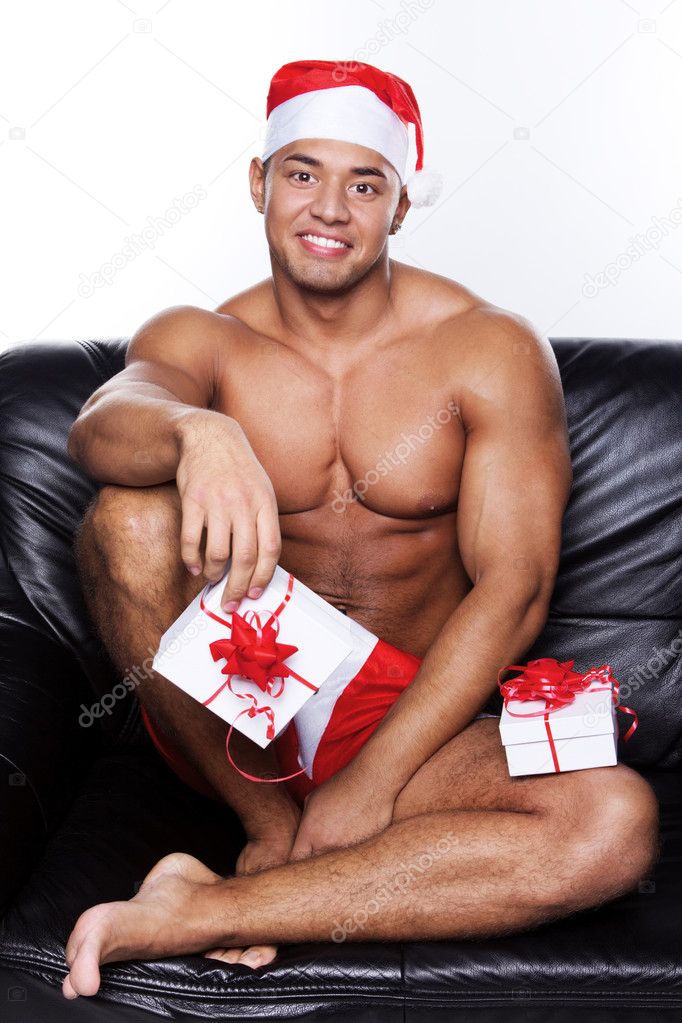Muscular man sitting on couch