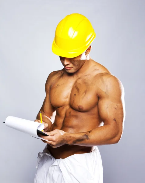 Young sexy worker writing on clipboard — Stock Photo, Image