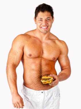 Young muscular man holding a hamburger clipart