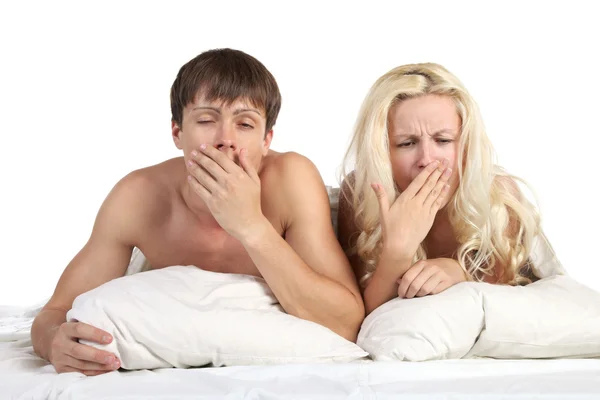 Young pair it yawns lying on the bed — Stock Photo, Image