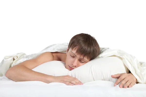 Junger Mann schläft im Bett — Stockfoto