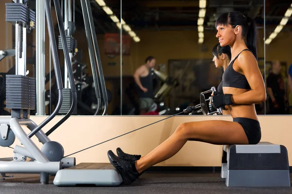 Beautiful woman is doing gym exercises — Stock Photo, Image
