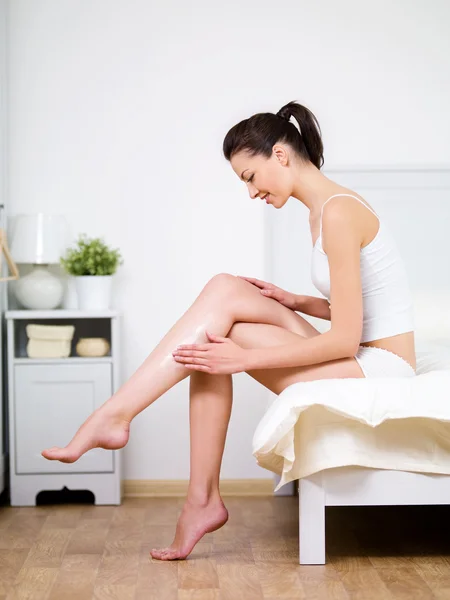 Woman caring of her beautiful legs — Stock Image Woman caring of her beautiful legs Royalty Free Stock Images