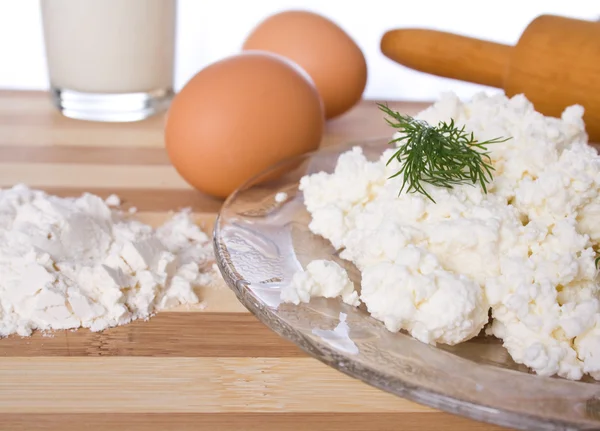 Baking ingredients, milk, flour, eggs and cheese on the table — Stock Photo, Image