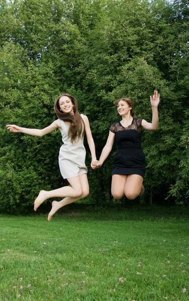 Two young cheerful women jumping — Stock Photo, Image