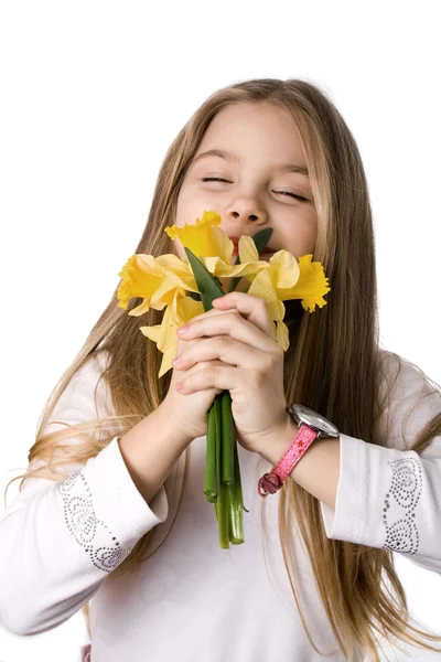 Beautiful little girl with a bouquet of daffodils — Stock Photo, Image