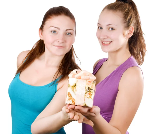Two happy beautiful girls holding a present — Stock Photo, Image