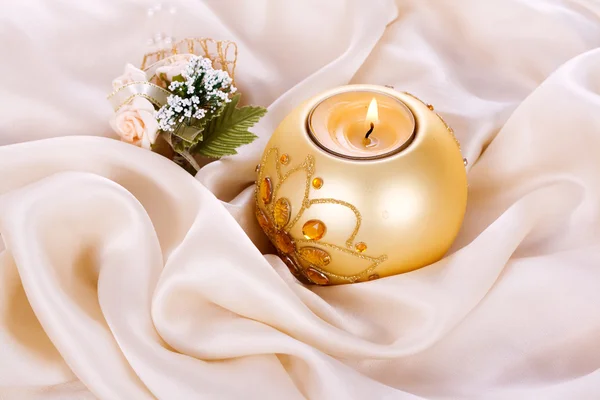 Holiday candle and flowers against Stock Photo