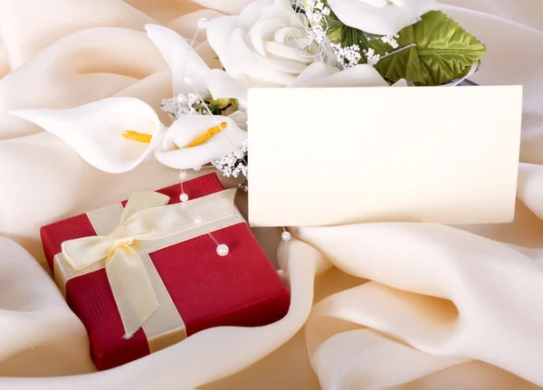 Holiday gift with a bouquet of the bride — Stock Photo, Image