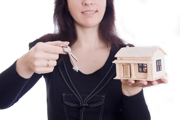 Woman's hands holding house and keys — Stock Photo, Image