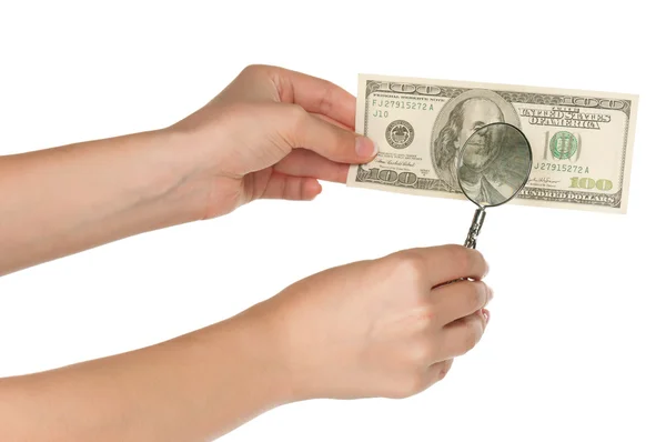Hand with magnifying glass and dollars — Stock Photo, Image