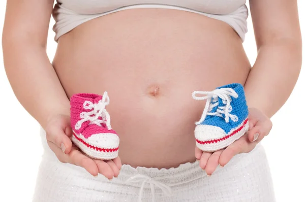 Schwangere mit Babystiefeln — Stockfoto