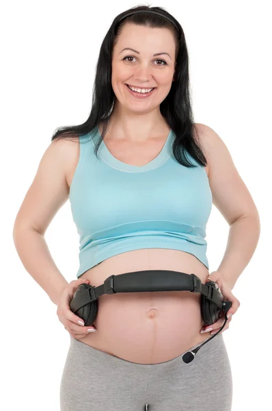 Pregnant belly with headphones Stock Photo